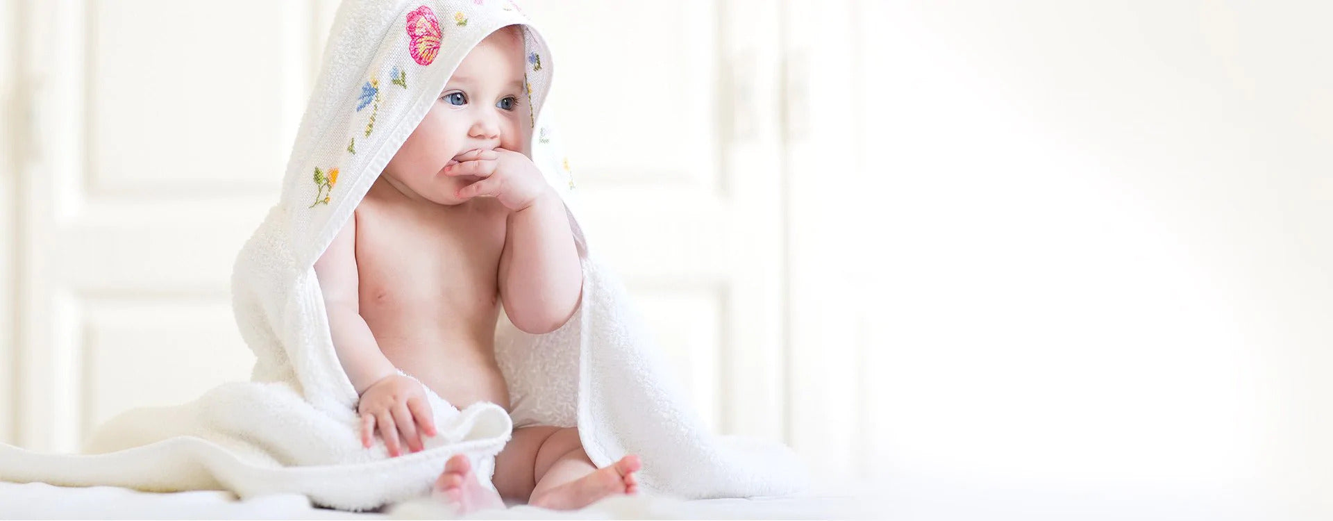 Baby sucking thumb in pajamas